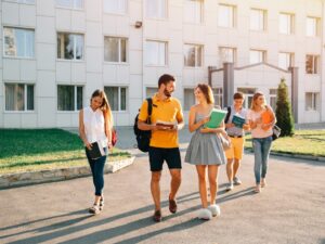 happy-college-students-with-books-hands-walking-together-campus_8353-6400