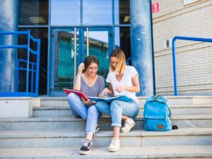 ladies-reading-textbook-near-university_23-2147860774